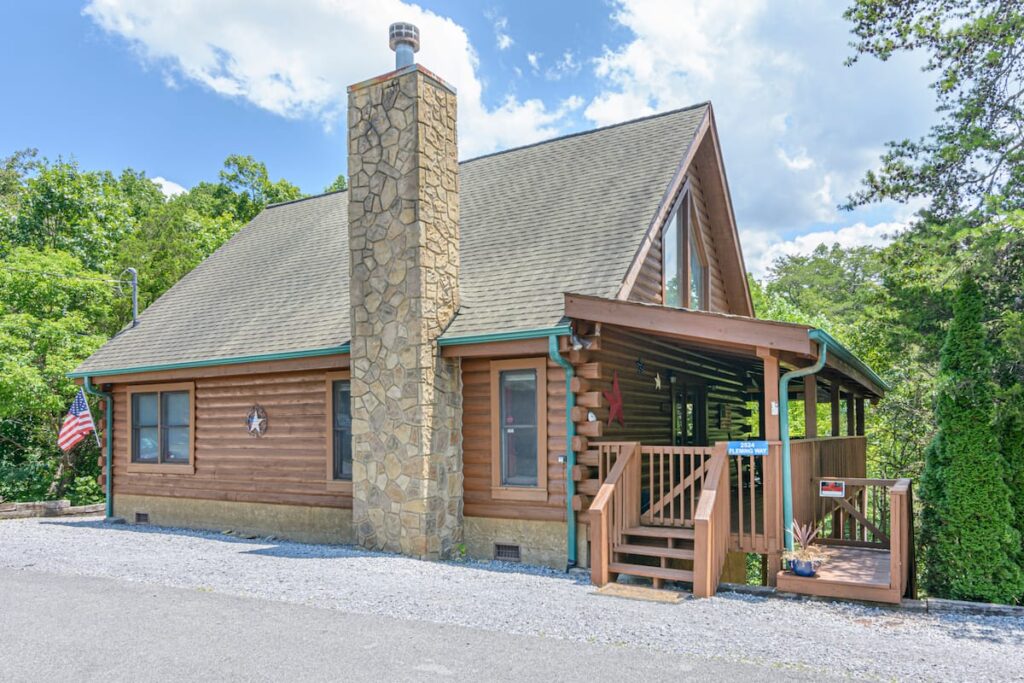 American Way Cabin exterior with covered porch and driveway