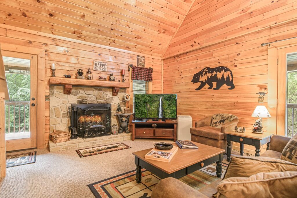 Mountain Mist wood-paneled living room with sofas and decorative fireplace