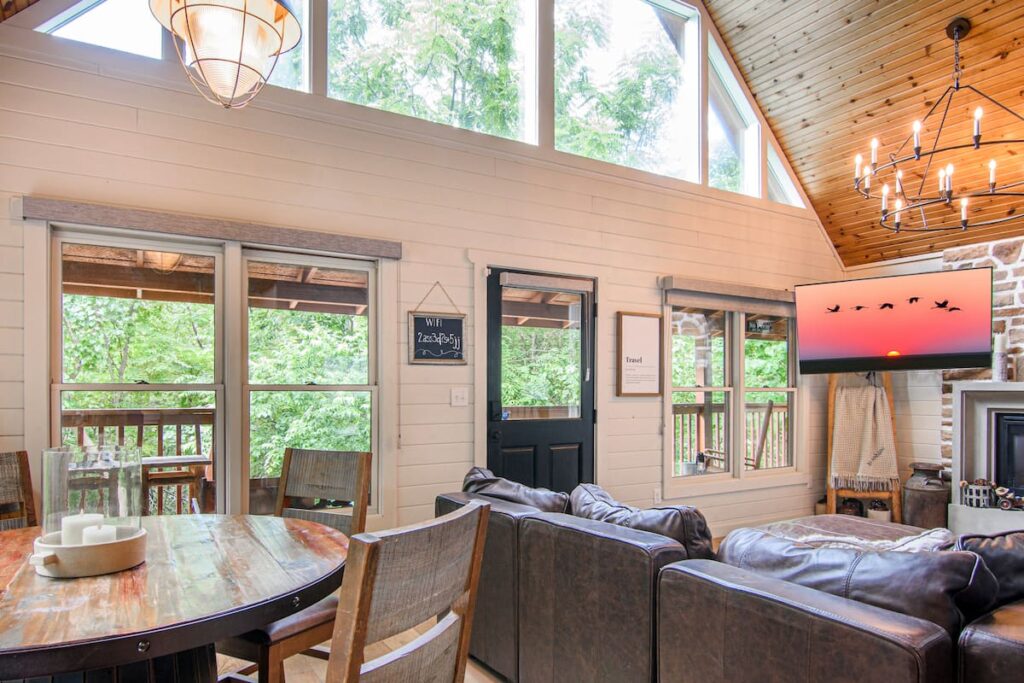 Bright vaulted living and dining room at The Moonshine Cabin